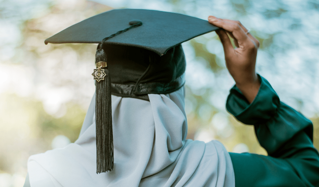 A female doctoral graduate in a hijab wearing an academic cap with an Islamic star tassel, representing Al-Mahdi Institute’s PhD scholarships and advanced Islamic research opportunities.